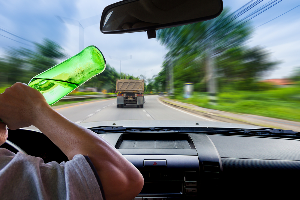 Truck driver drinking alcohol while driving