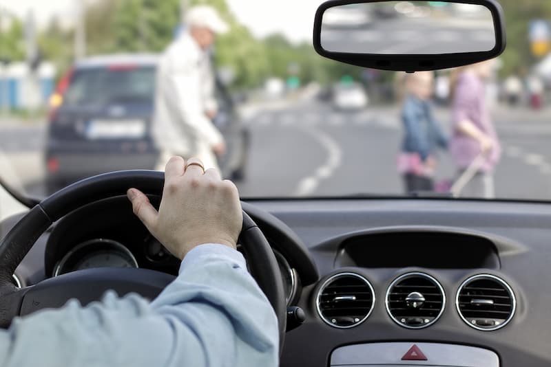 Driver slows down in front of pedestrians