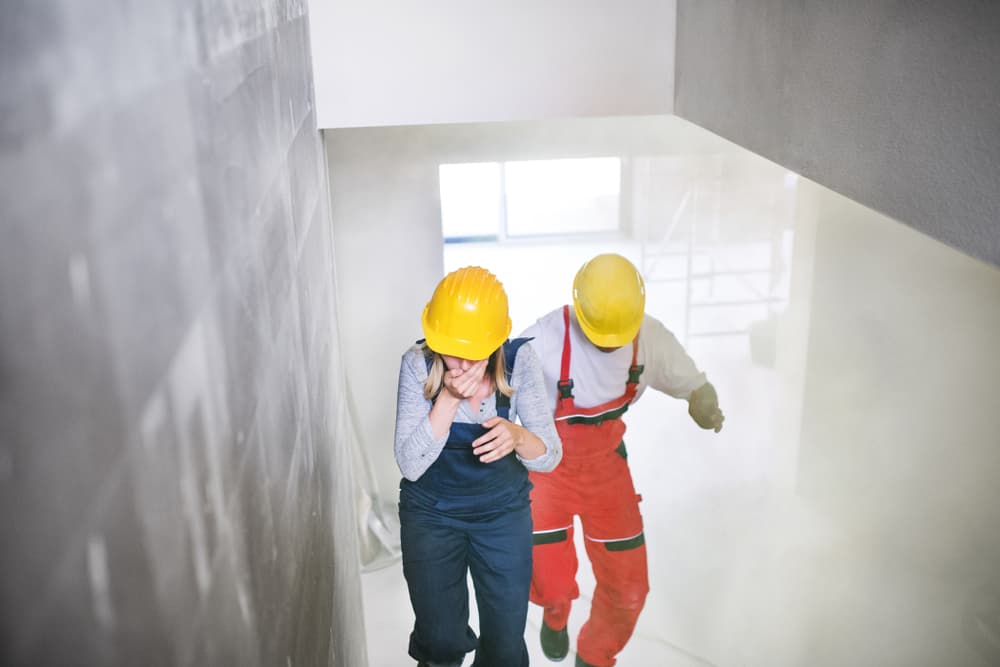 woman and man running up the stairs after accident