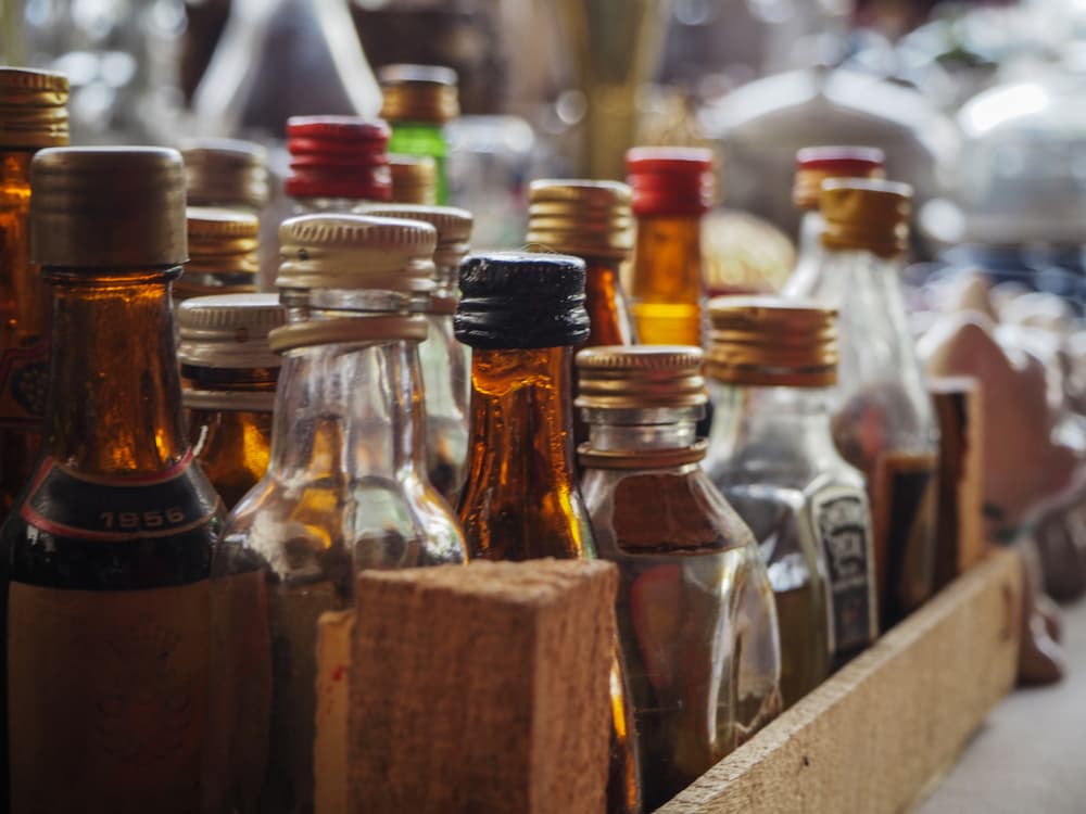 old small liquor bottles in wooden box