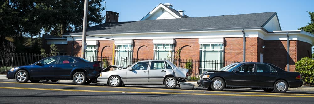 Three cars involved in an accident on a city street