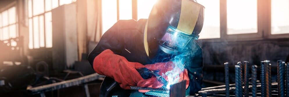 employee welding in a factory