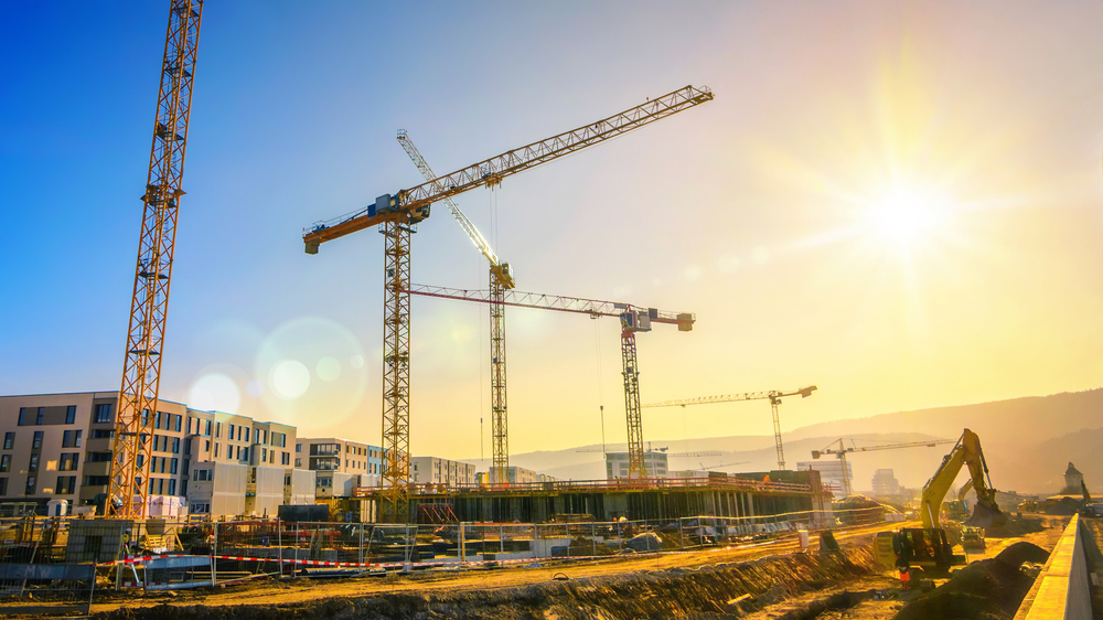 skyline of cranes over construction site